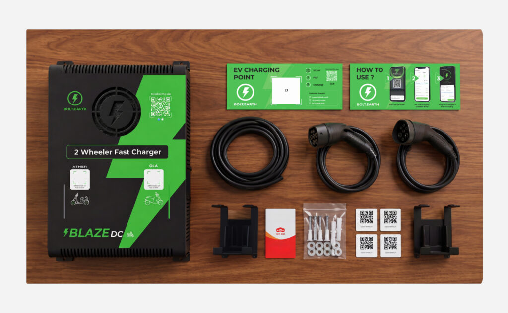 Blaze DC 3kW Dual Gun EV charger package contents showing charging guns, mounting brackets, installation kit, activation cards, SIM card, and setup documentation.